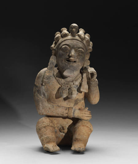 Seated Male Figure With Trophy Heads