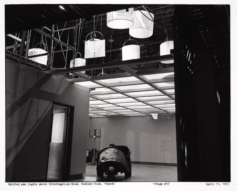 Skirted pan lights above interrogation room; feature film 