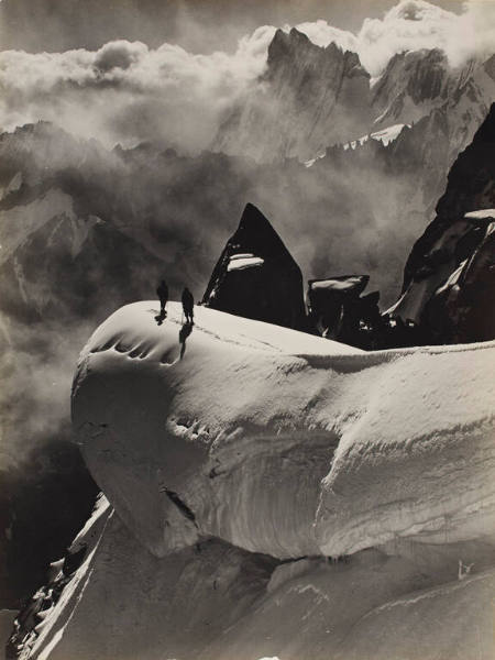 Two climbers traversing the Aiguille du Midi and Aiguille du Plan, Chamonix, France