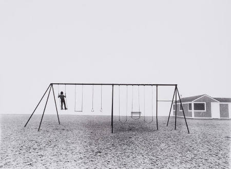 Boy standing on swing, Westport, Connecticut