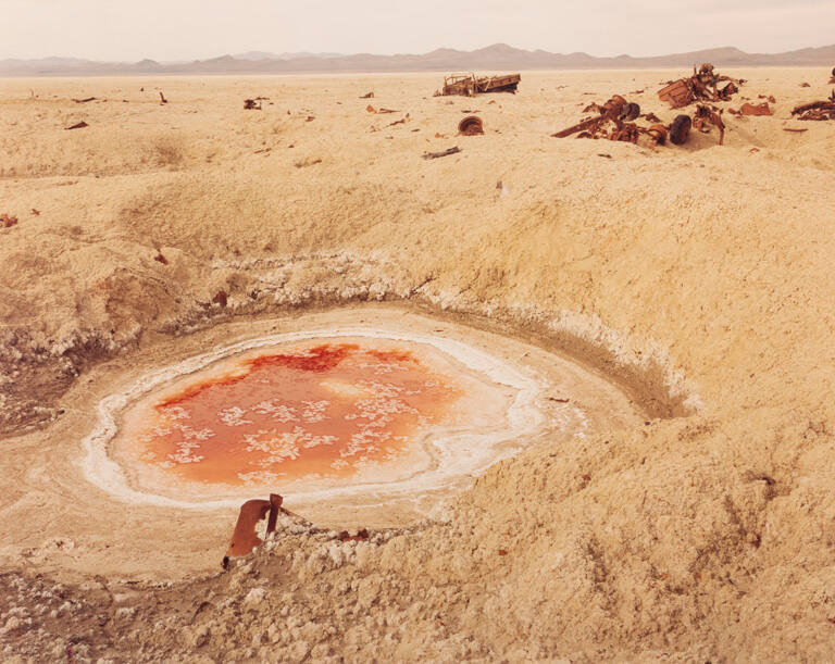 Bomb crater and destroyed convoy