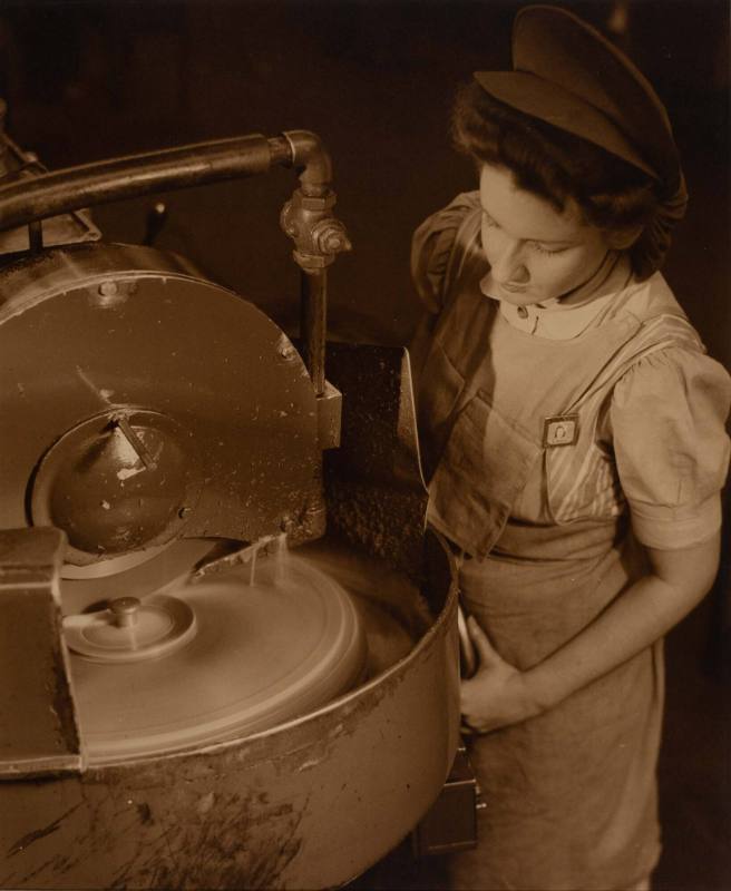 [Woman working at a machine, high angle]