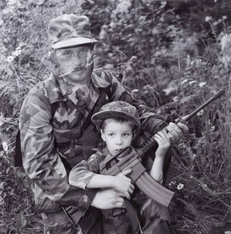 Father and son with machine gun, from the series Aryan Nations