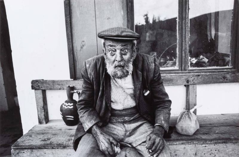 Old glaring man on bench, Turkey