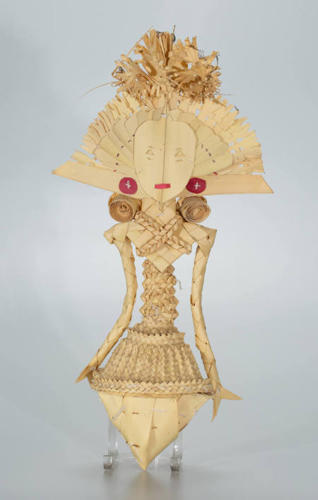Elaborately costumed Cili figure with feathered wings and skirt