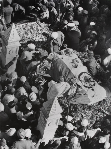 [Lying in state, Gandhi's body is covered by the flag of the new India]