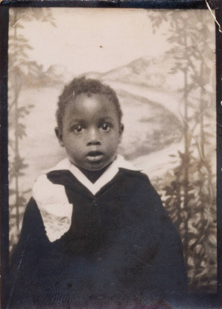 Photo booth portrait of child wearing top with V-neck collar
