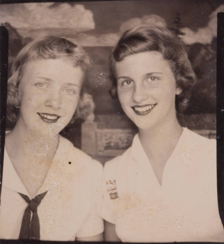 Photo booth portrait of two young women or teens, one wearing a nautical style necktie