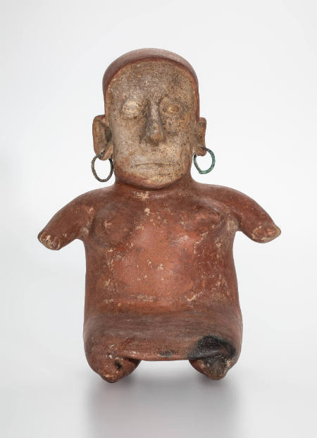 Seated female figure with copper earrings