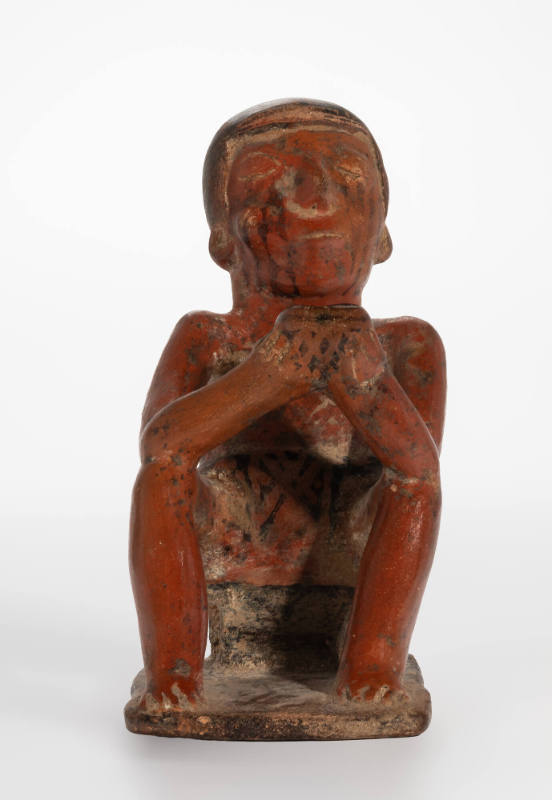 Seated male figure chewing coca