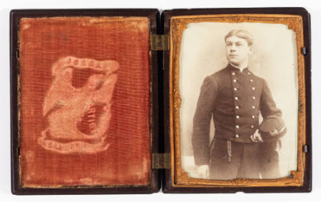 Untitled [Standing young man in uniform, left hand holding cap]
