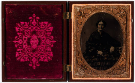 Untitled [Middle-aged woman in ruffled skirt; cheeks enhanced in red and jewelry painted gold]