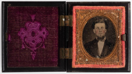 Untitled [Young man with bow tie and goatee, cheeks enhanced with red]