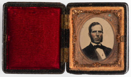 Untitled [Man with long, bushy sideburns, cheeks enhanced in red]