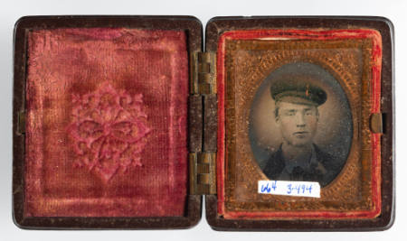 Untitled [Young man in cap, cheeks enhanced with red]