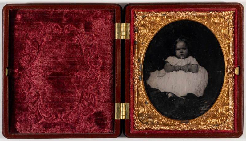 Untitled [Small child sitting on lap, rest of person obscured]