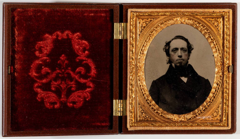 Untitled [Young, bearded man, cheeks enhanced in red]