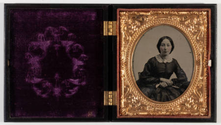 Untitled [Young woman, hands crossed, cheeks enhanced in red]