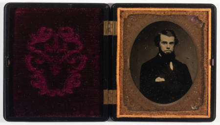 Untitled [Bearded young man, handkerchief in breast pocket, cheeks lightly enhanced in red]