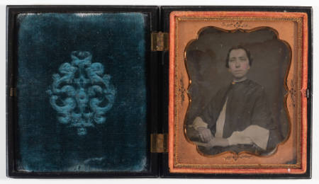 Untitled [Seated woman, hands clasped in lap, cheeks enhanced in red, jewelry painted gold]