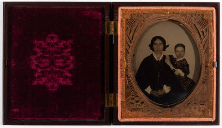 Untitled [Woman and child, wearing striped dress, both with cheeks enhanced in red]