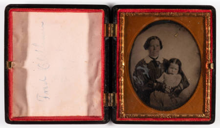 Untitled [Woman holding a young child, cheeks on both enhanced in red]