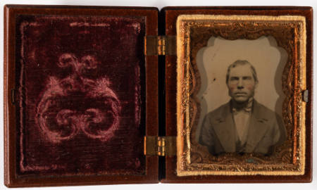 Untitled [Man with long sideburns, cheeks enhanced in red]
