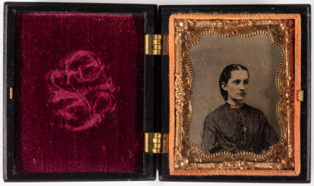 Untitled [Serious young woman, cheeks and bow at neck enhanced in red]