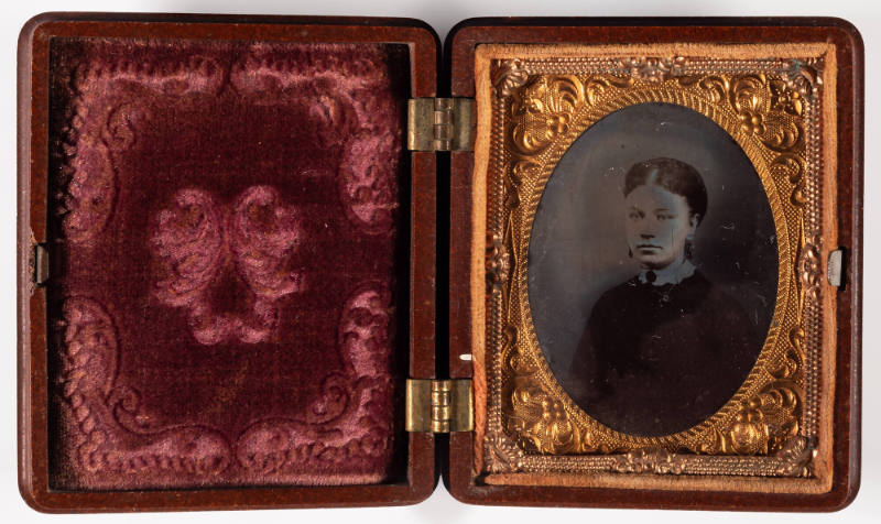 Untitled [Woman wearing earrings and a lace collar]