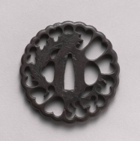 Openwork Tsuba with scalloped edges with holly leaf