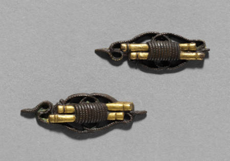 Menuki depicting rolled scrolls
