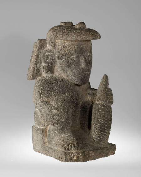 Seated figure with Tlaloc mask and maize