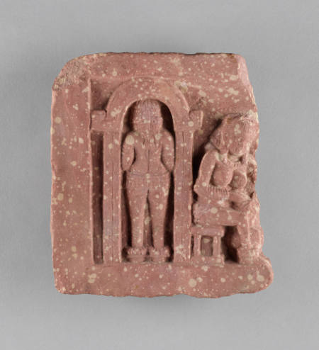 Household scene of woman churning butter and woman entering house
