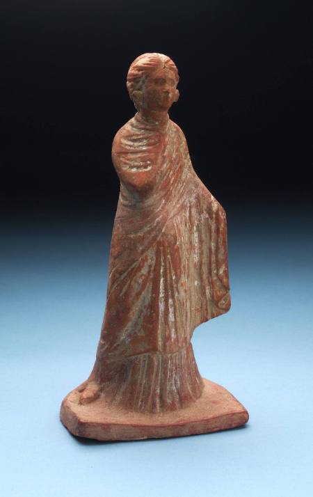 Standing female figure with right hand on chest