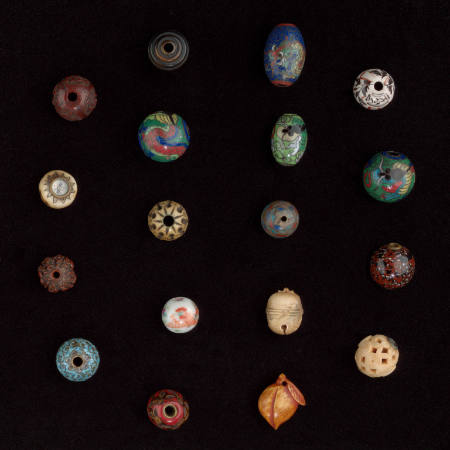 Ojime with carved design of a basket weave with hypnotic circles in a ring around middle