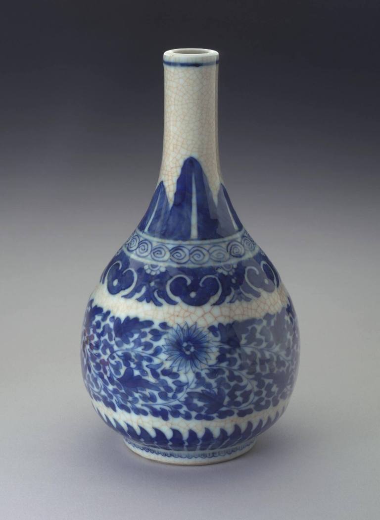 Pear-shaped bottle vase on foot ring with chrysanthemum scrolling motifs.  Banana leaves on neck