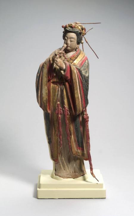 Figure of a woman playing a pipe instrument