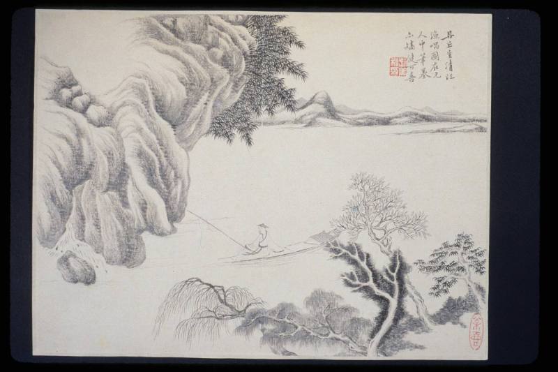 Fisherman in a boat beside cliffs