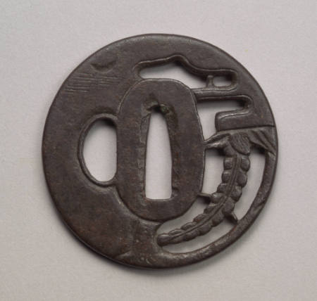 Pierced and carved tsuba with a fern and clouds