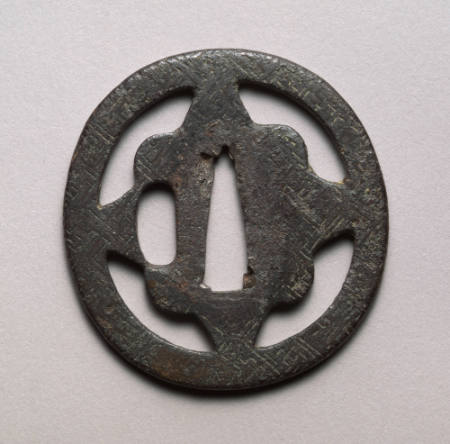 Oval tsuba with pierced quatrefoil design with engraved diaper pattern