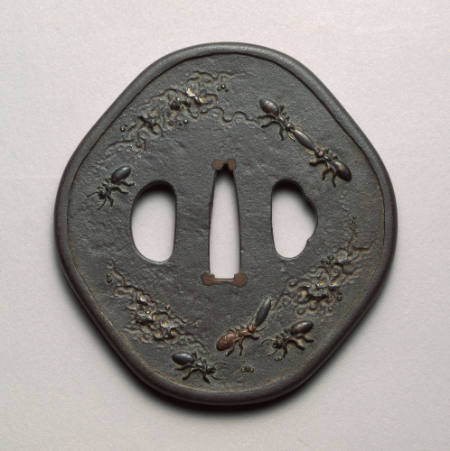 Rounded octagonal tsuba inlaid with raised relief ants and engraved flowers