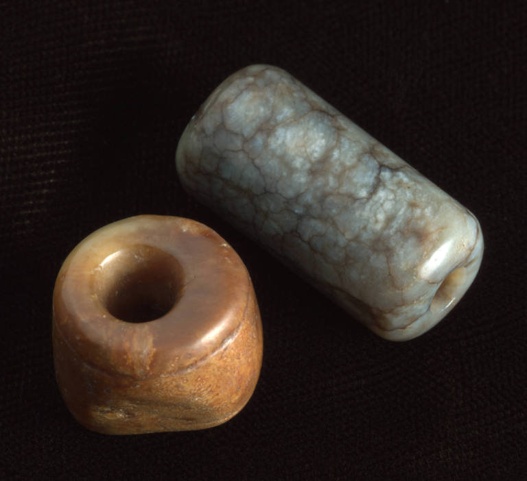 Two archaic sleeve weights
