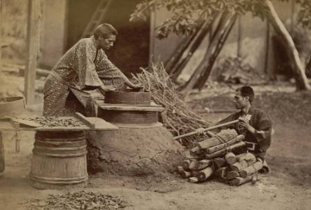 [Two men working at crude stove]