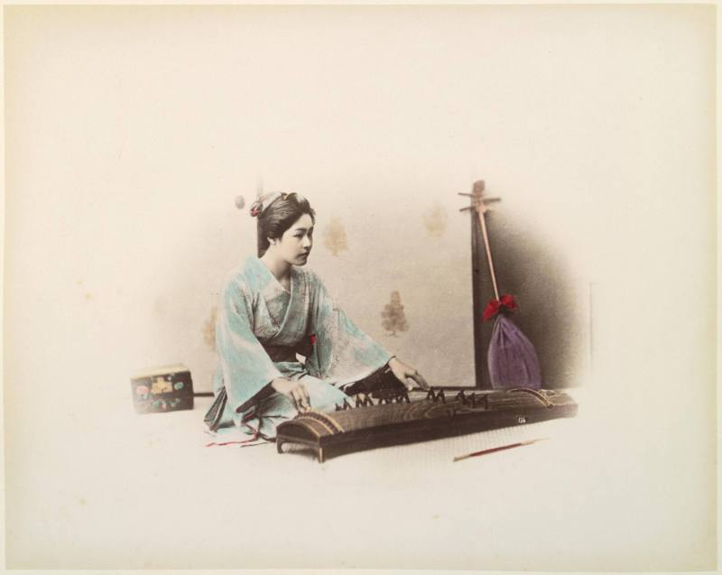 [Woman playing Koto]