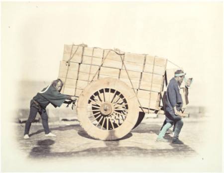 [Men moving a loaded cart]