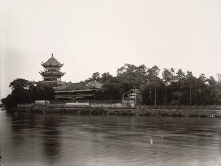 [Pagoda and temple on riverbank]