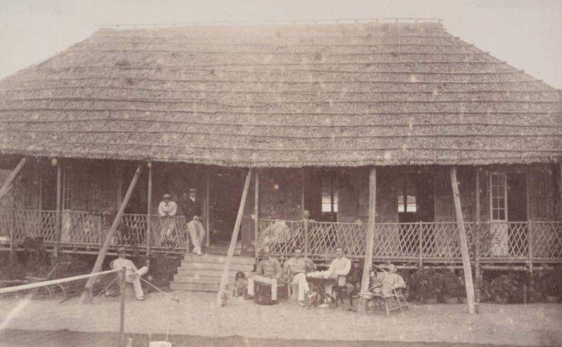 [Straw roofed building]