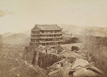 [Four-story building within a walled city]