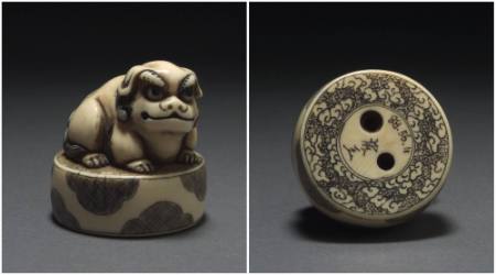 Carved ivory netsuke of a SHISHI (Fu dog) seated on a drum