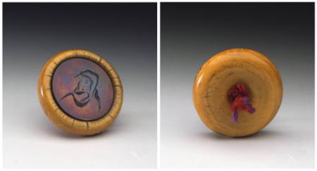 Kagamibuta netsuke with a female face